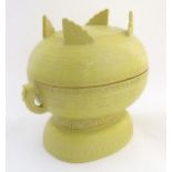 A Chinese yellow ground lidded pot raised on a foot, with twin handles formed as stylised elephant