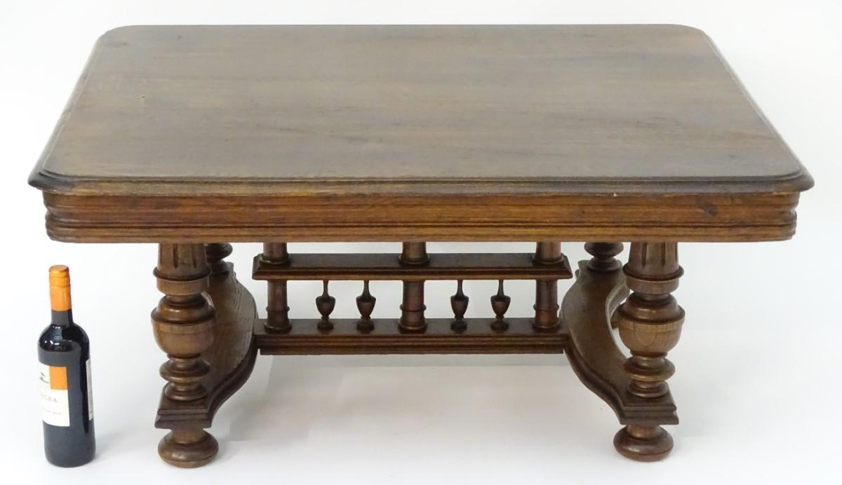 A 20thC oak table with a rectangular moulded top, four turned tapering legs with fluted decoration - Bild 2 aus 6