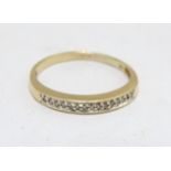 A 9ct gold ring with chip set diamonds in a linear setting. Ring size approx Q 1/2 Please Note -