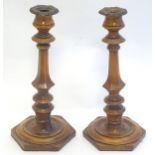 Treen: A pair of 19thC turned and carved wooden candlesticks with hexagonal bases. Approx. 10 3/4"