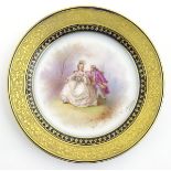 A cabinet plate in the manner of Sevres, decorated with an 18thC gentleman and lady sat in a