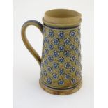 A 19thC Doulton Lambeth jug decorated with flowers in relief designed by Louisa Matterson. Bears