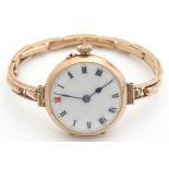 A 9ct gold case ladies wrist watch with enamel dial. the dial approx 1" diameter Please Note - we do