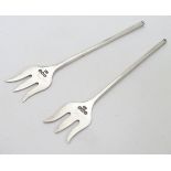 A pair of small olive / sweetmeat forks hallmarked Sheffield 1934 maker Viner's Ltd. 3" long. (8g)