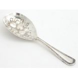 A silver caddy spoon with fruit / berry decoration to bowl hallmarked Birmingham 1976 maker