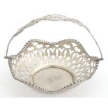 A white metal bon bon dish with pierced decoration and swing handle 3 1/4" Please Note - we do not
