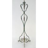 A late 19th / early 20thC wrought iron standard lamp with a verdisgris finish and gilt foliate