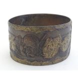 A Japanese napkin ring with theatrical mask detail in relief. Approx. 2" diameter Please Note - we