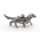 A Novelty Continental silver pendant / charm formed as a Dachshund / hunting dog. Probably