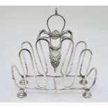 A silver plate toast / letter rack with scroll and shell decoration 7" high x 6 3/4" long Please