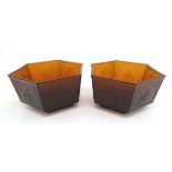 A pair of Art Deco dark amber hexagonal glass bowls, decorated with various images of kingfishers in