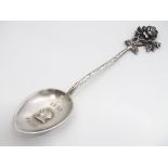 A Victorian silver teaspoon with rose decoration to handle and image of Queen Victoria to bowl.