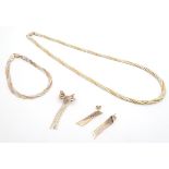 A 9ct three colour gold suite of jewellery comprising necklace, bracelet, brooch and earrings ,