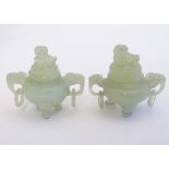 A pair of miniature carved jade koros raised on three feet, with twin handles with ring