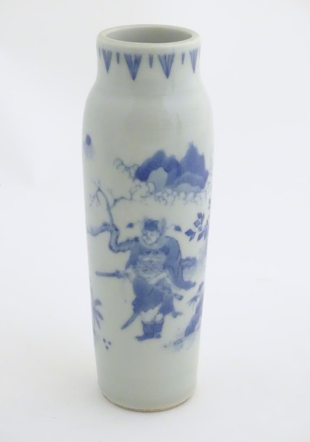 A Chinese blue and white vase of narrow form, depicting figures in a stylised landscape. Approx. 8