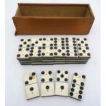 Toys: A set of bone and ebony dominoes contained within in a sliding wooden box. Each piece