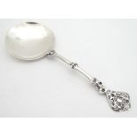 A Victorian silver spoon with large circular bowl and figural detail to handle. Hallmarked London