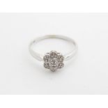 A 14ct white gold ring set with chipset diamonds. Ring size approx size N. Please Note - we do not