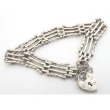 A silver bracelet with padlock clasp and safety chain. Approx 7 1/2" long Please Note - we do not