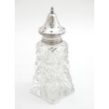 A cut glass caster with silver top hallmarked London 1930 make Henry Perkins & Sons. 6" high