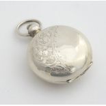 A white metal sovereign case of pocket watch form 1 3/4" long Please Note - we do not make reference