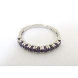 A 9ct gold ring set with 9 amethysts in a linear setting. Ring size approx. K 1/2 Please Note - we