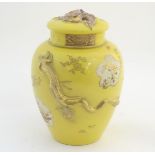 A Chinese yellow ground ginger jar with lid and lid liner. The body with gilt decoration in relief
