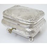 A Continental silver box with floral decoration, and standing on four ball feet 6'' wide x 5''