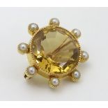 A late 19thC / early 20thC gilt metal brooch set with facet cut citrine bordered by 8 pearls. 1"