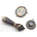 Assorted jewellery comprising a 19thC carved wooden pendant formed as a hand, a 19thC brooch with