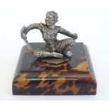 A white metal figure modelled as a seated deity. Approx. 2 1/2" high. Please Note - we do not make