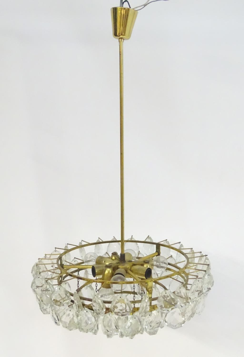 A mid 20thC Italian electrolier, having nine lights illuminating five tiers of glass droplets /