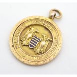 A 9ct gold fob medal by Thomas Fattorini, Birmingham, with enameled Wiltshire Football Association