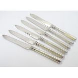 A Set of 6 silver handled knives hallmarked Sheffield 1919 maker Thomas Bradbury & Sons Ltd. 7" long