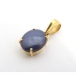 A 14kt gold pendant set with sapphire star cabochon 1" long Please Note - we do not make reference