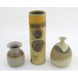 Three studio pottery vases, a tall hand built vase with cut and incised roundel decoration, by Bob