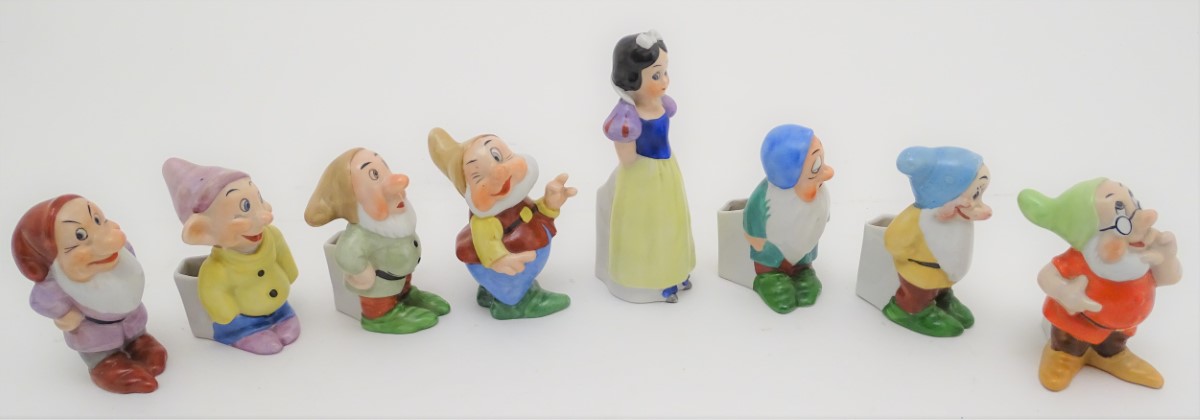 A mid-20thC ceramic novelty set of bud vases, formed as Snow White and the seven Dwarves. The - Image 5 of 9