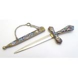 An early 20thC enamelled chatelaine paper knife formed as a sword and scabbard. Approx. 5 1/4" long.