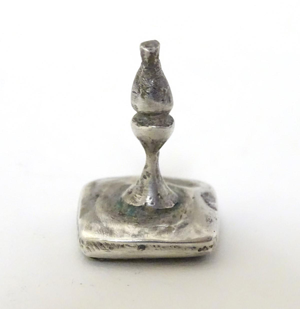 A white metal fob seal with hard stone seal under engraved with Arabic / Islamic script approx 1" - Image 2 of 7