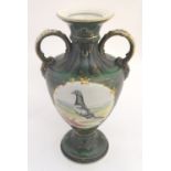 A 20thC baluster vase with a bulbous body, flared foot and rim and twin loop handles. Decorated with