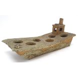 A studio pottery stoneware egg stand in the form of a steam barge, with the provision for 6 eggs.