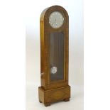 An early / mid 20thC Art Deco longcase clock with a quarter striking movement within a figured