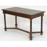 A late 19thC table with an oak top above a walnut base, having a single short drawer to one end