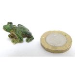 A cold painted bronze modelled as a frog. Approx. 1/2" high. Please Note - we do not make