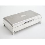 A silver plate table top cigarette box with engine turned decoration. 6 1/2" x 3 1/2" x 1 3/4"