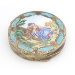A gilt metal powder compact with enamel decoration to lid. 2 3/4" diameter Please Note - we do not