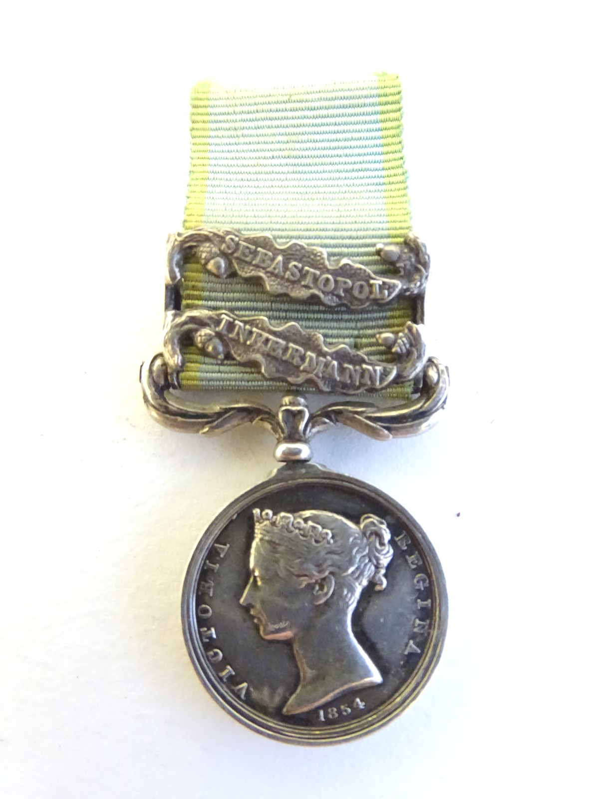 Militaria: a Victorian miniature Crimea Medal, with Sebastopol and Inkermann bars. 2" long (