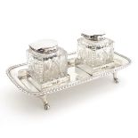 A silver inkstand with twin cut glass ink bottles with silver mounts. Hallmarked Sheffield 1903