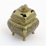 A Chinese lidded cast brass censor of squat form with panelled foliate decoration to sides, raised