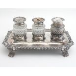 A 19thC Old Sheffield Plate inkstand / standish with three cut glass bottles on a four footed